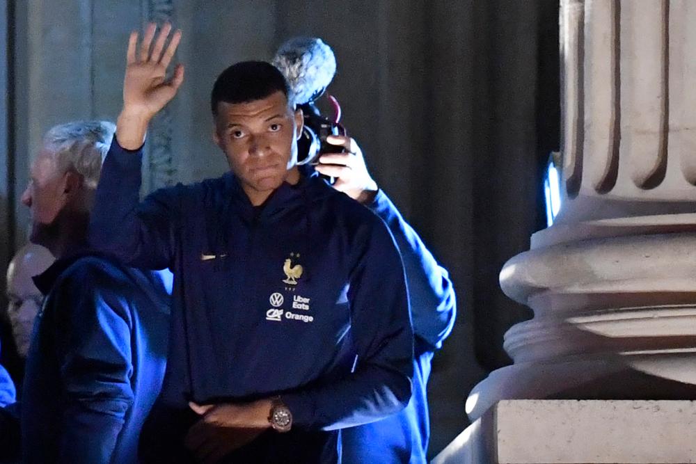 France’s forward Kylian Mbappe greets supporters at the Hotel de Crillon, a day after the Qatar 2022 World Cup final match against Argentina, at the Place de la Concorde in central Paris on December 19, 2022/AFPPix