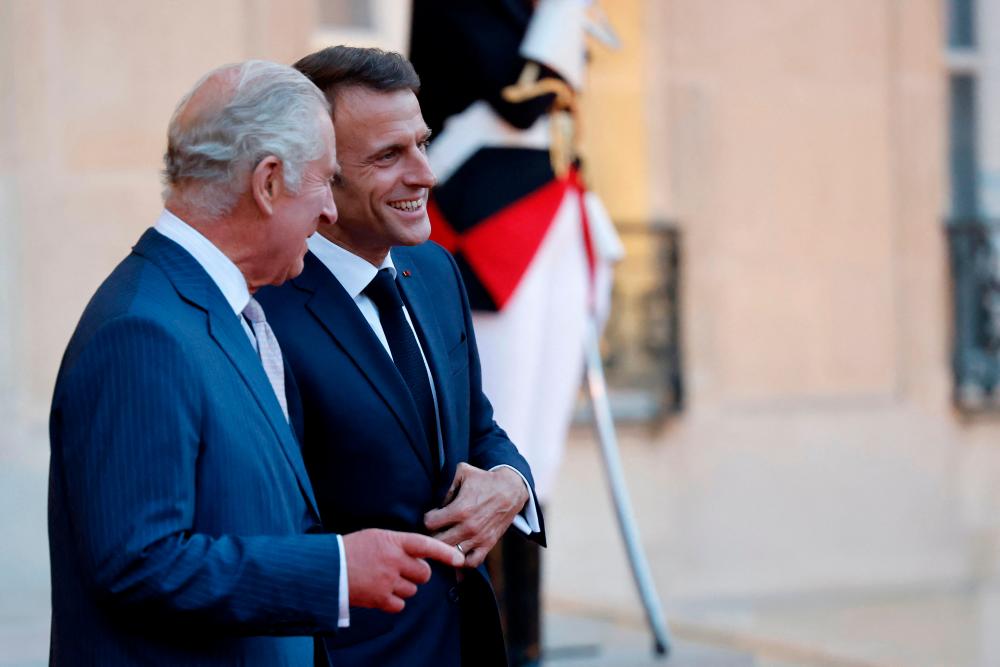 Britain's King Charles III (L) bids farewell to French President Emmanuel Macron at the Elysee Presidential Palace in Paris, on September 21, 2023, before departing for Bordeaux, where the King and Queen will continue their three day state visit to France. AFPPIX