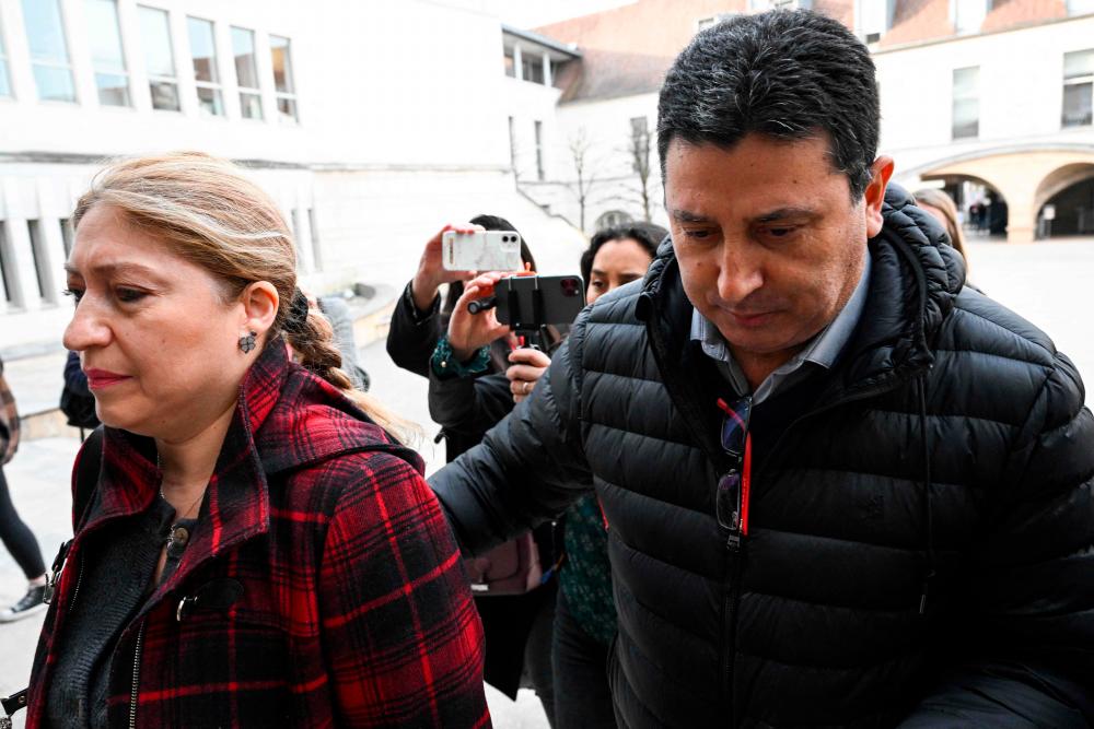 Humberto (R) and Ana Luz Zepeda, the parents of Nicolas Zepeda, a Chilean man accused of murdering his Japanese ex-girlfriend in France in 2016, arrive at the courthouse of Besancon, on March 29, 2022, on the first day of their son's trial/AFPPix