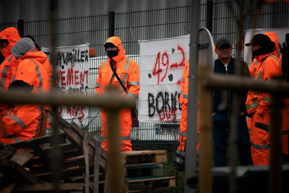 Unionists gather at an entrance to the CETCO - Centre Technique Communautaire cleaning services center, during strike action, near Le Havre, northwestern France on March 20, 2023. AFPPIX