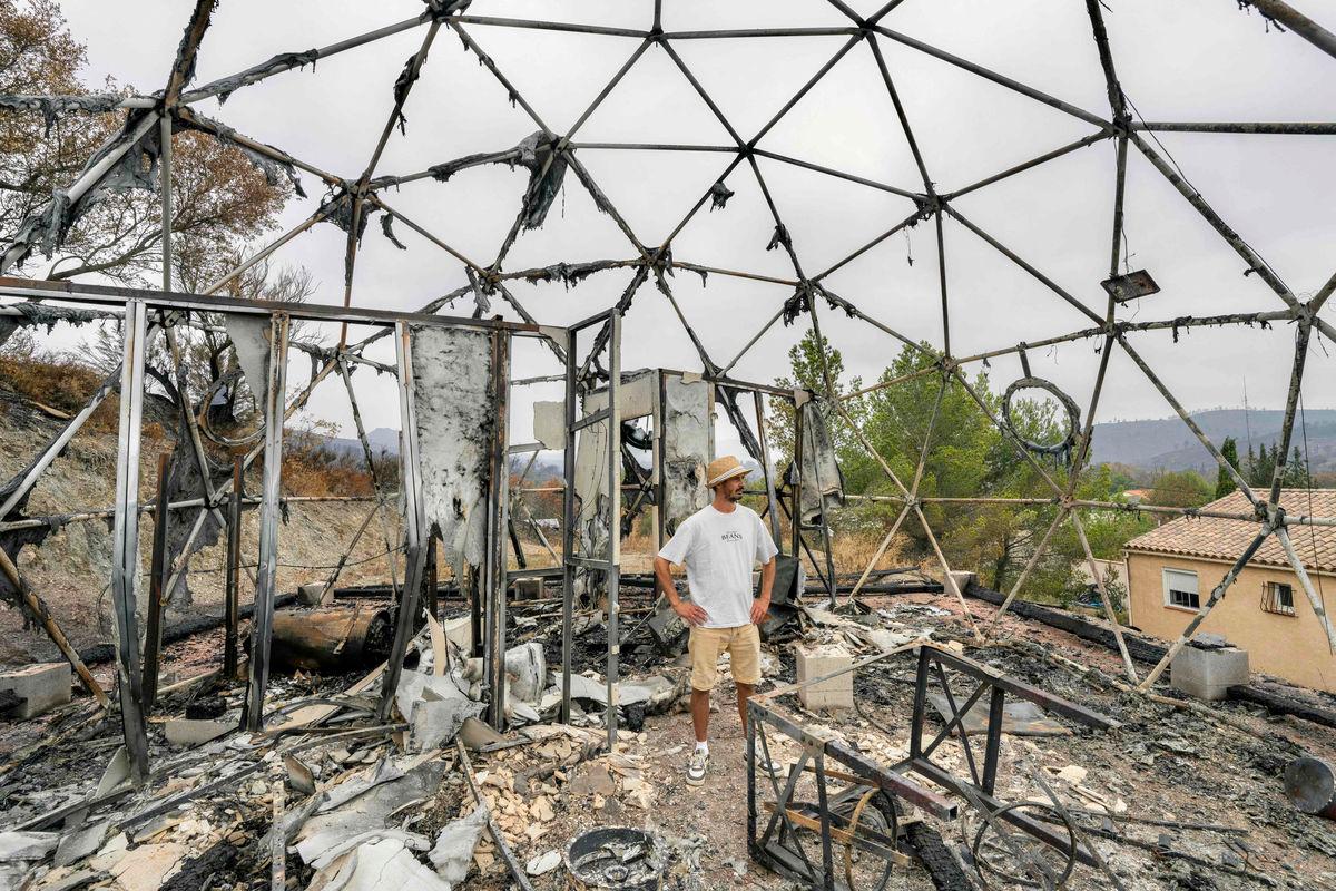 The owner of a tourist bubble home stands amid the damage caused following wildfires in Durban-Corbieres, in the Aude department, southern France on August 9, 2025- Photo by Idriss Bigou-Gilles / AFP
