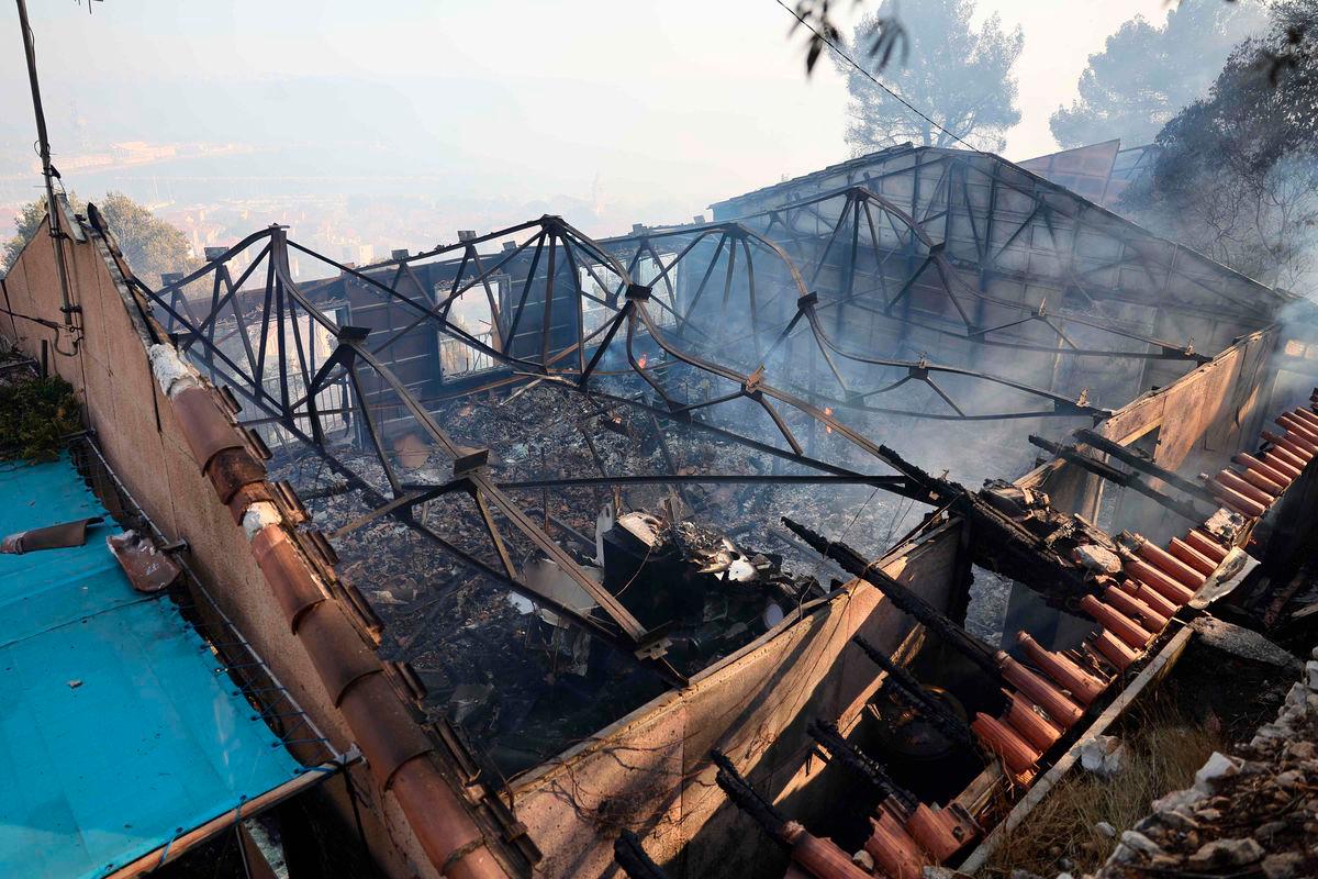 This photographs shows a burnt out building in the aftermouth of a wildfire in the L’Estaque district of Marseille - AFPPix