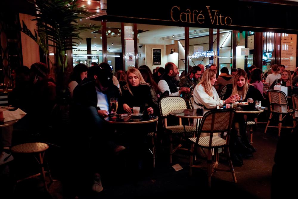 People have drinks on a bar’s terrasse in Paris on September 26, 2020, two days before new measures come into effect to curb the spread of Covid-19. — AFP