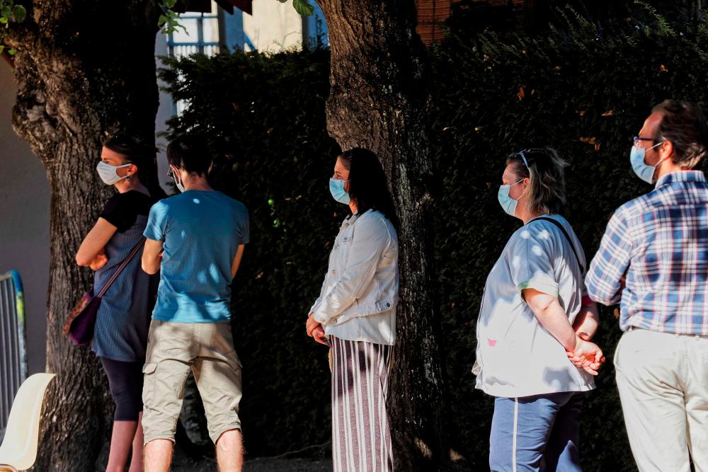 People queue to undergo a Covid-19 test, in Montargis on July 7, 2020, as part of a massive testing campaign in the area after an outbreak cluster was identified amid the crisis linked with the Covid-19 pandemic caused by the novel coronavirus. — AFP