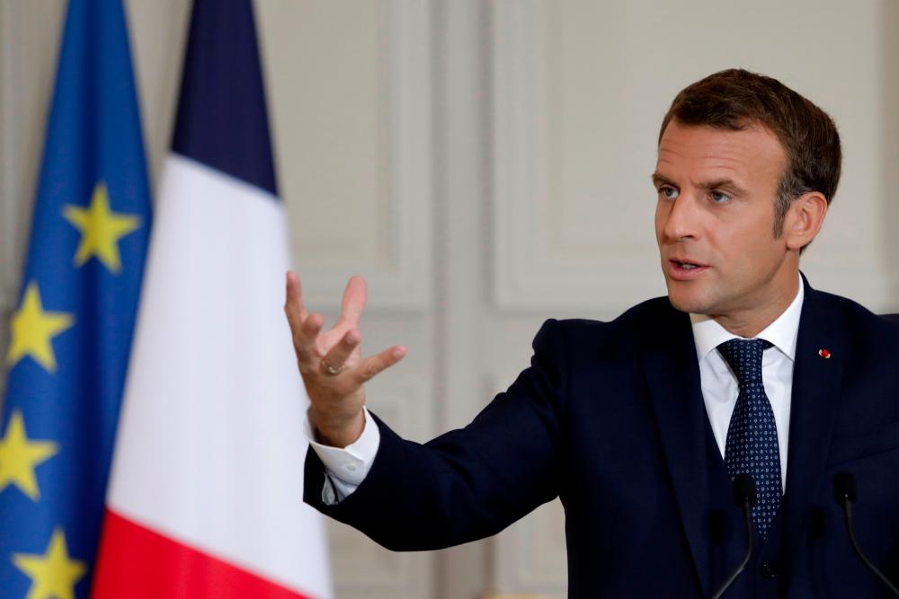 French President Emmanuel Macron reacts as he speaks during a press conference on the political and economical situation in the Lebanon, where he accused Lebanon’s leaders of betraying their promises over the failure to form a government in the wake of the giant blast at the Beirut port in August on Sept 27, 2020 in Paris. — AFP