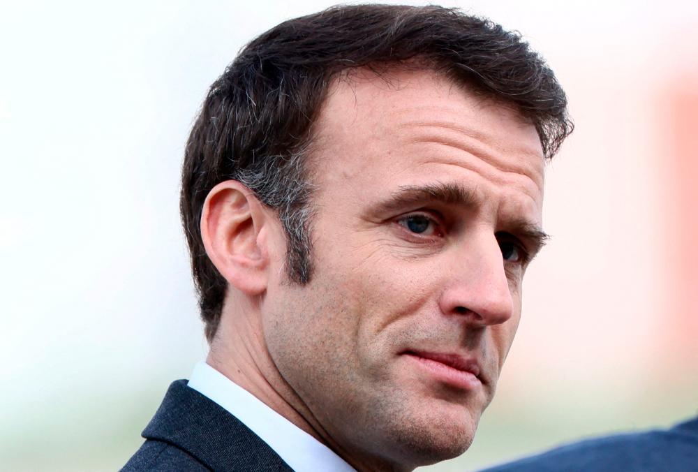 French President Emmanuel welcomes freed French hostage journalist Olivier Dubois (unseen) who was held hostage in Mali for nearly two years by the Support Group for Islam and Muslims (GSIM), reacts as he arrives at the Villacoublay airport, in Velizy-Villacoublay, near Paris, on March 21, 2023/AFPPix