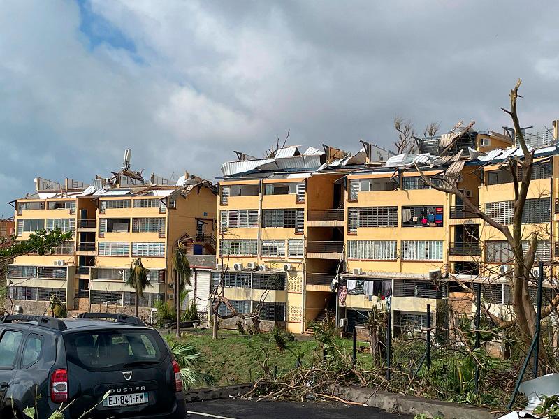 A photo taken on December 15, 2024 shows torn-off roofs of residential buildings after the cyclone Chido hit France’s Indian Ocean territory of Mayotte. At least 14 people were killed in Mayotte when a fierce cyclone battered the French Indian Ocean territory, authorities said on December 15, 2024, with officials warning it will take days to know the full toll. - KWEZI / AFP