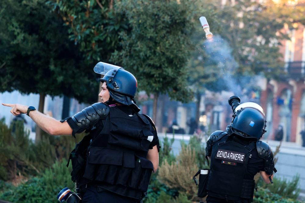 French Gendarmes fire a tear gas round towards protestors during an unauthorized demonstration in support of Palestinians in Toulouse, southwestern France, on October 12, 2023. AFPPIX