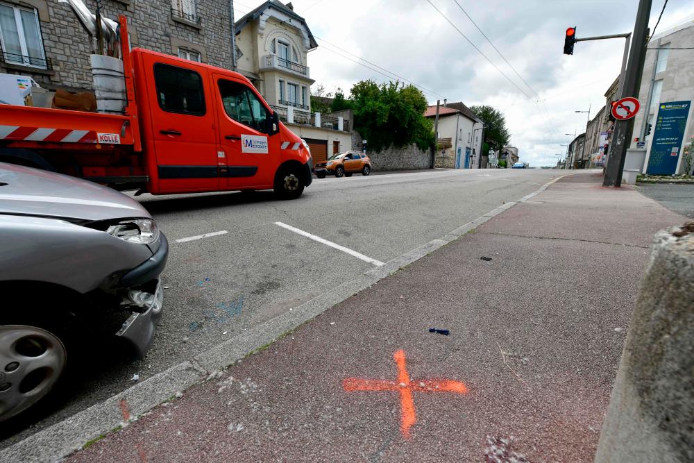 This photograph taken on August 6, 2023, shows a painted X representing the location of a body of one of the two men killed in an accident after a vehicle hit a scooter during the night between August 5 and 6, 2023, in Limoges, central France. AFPPIX