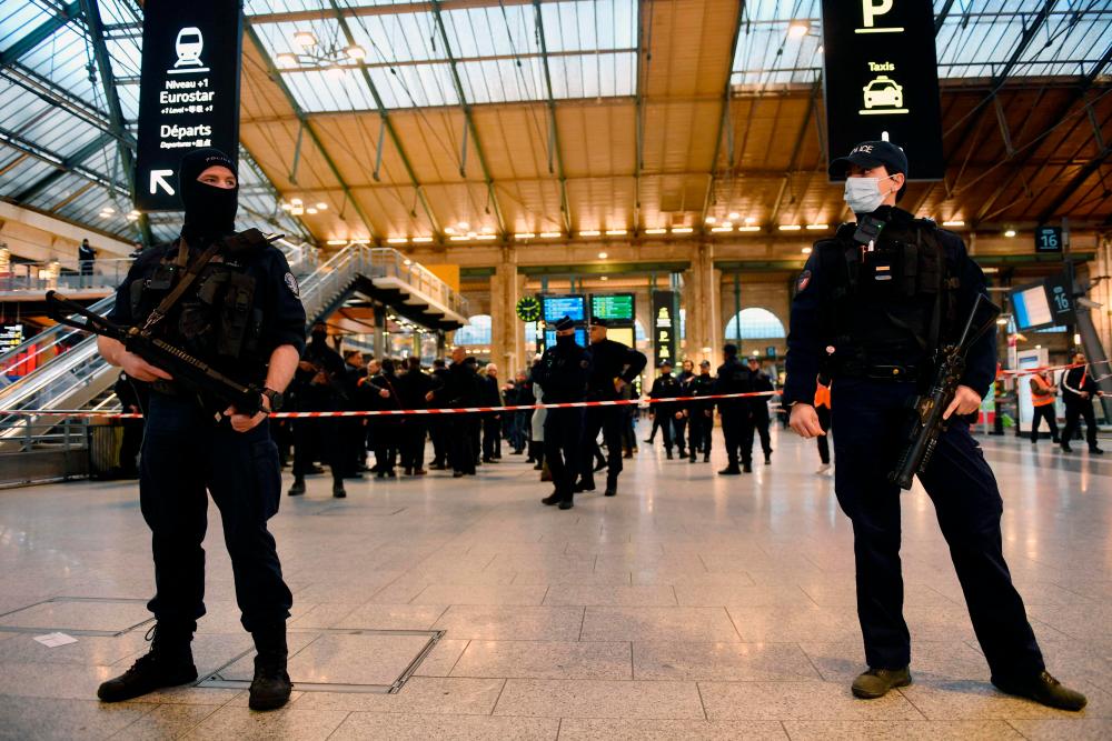 French police stand guard in a hall of Paris’ Gare du Nord train station, after several people were lightly wounded by a man wielding a knife on January 11, 2023/AFPPix