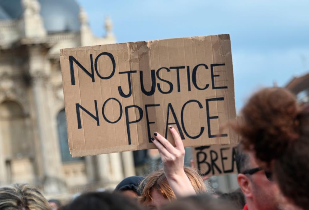 A person holds a placard during a demonstration on June 4, 2020, in Lille, northern France, against racism and police violence. — AFP