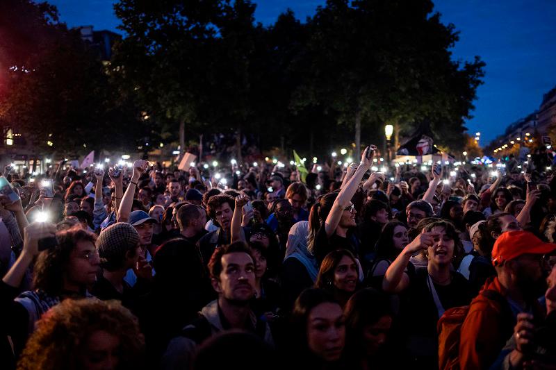 People celebrate during an election night rally following the first results of the second round of France’s legislative election at Republique Square in Paris on July 7, 2024. A broad left-wing coalition was leading a tight French legislative election, ahead of both President’s centrists and the far right with no group winning an absolute majority, projections showed. - AFPpix