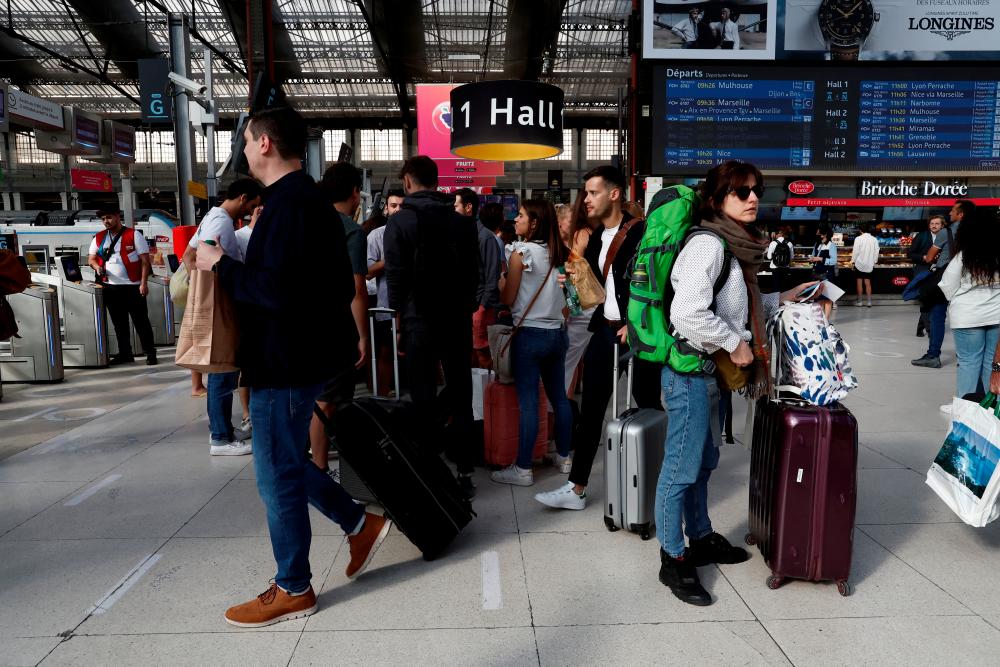 Travelers on the concourse wait for their train during a nationwide strike by France's national state-owned railway company SNCF workers, at Gare de Lyon train station in Paris, France, July 6, 2022. REUTERSpix