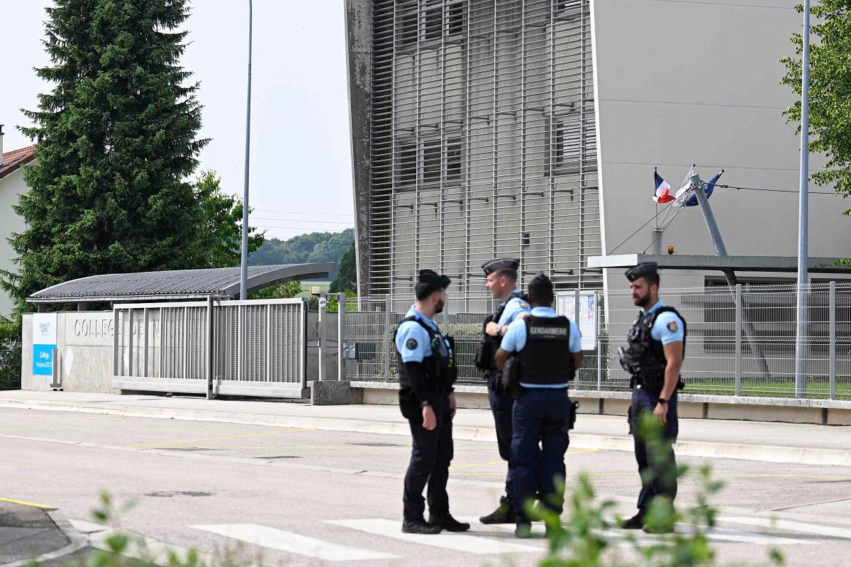 French gendarmes stand guard outside a secondary school, where a 31-year-old teaching assistant was stabbed with a knife by a 15-year-old pupil during a bag search in Nogent, eastern France on June 10, 2025. The teaching assistant, who died of her wounds, received several knife wounds just as classes were starting, and the alleged attacker, who was overpowered by gendarmes, “appears to be a student at the school,“ education officials said. - Jean-Christophe VERHAEGEN / AFP