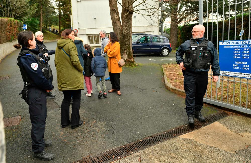 Police officers secure the entrance of Saint-Thomas d’Aquin middle school where a teacher died after being stabbed by a student, in Saint-Jean-de-Luz, southwestern France, on February 22, 2023. AFPPIX
