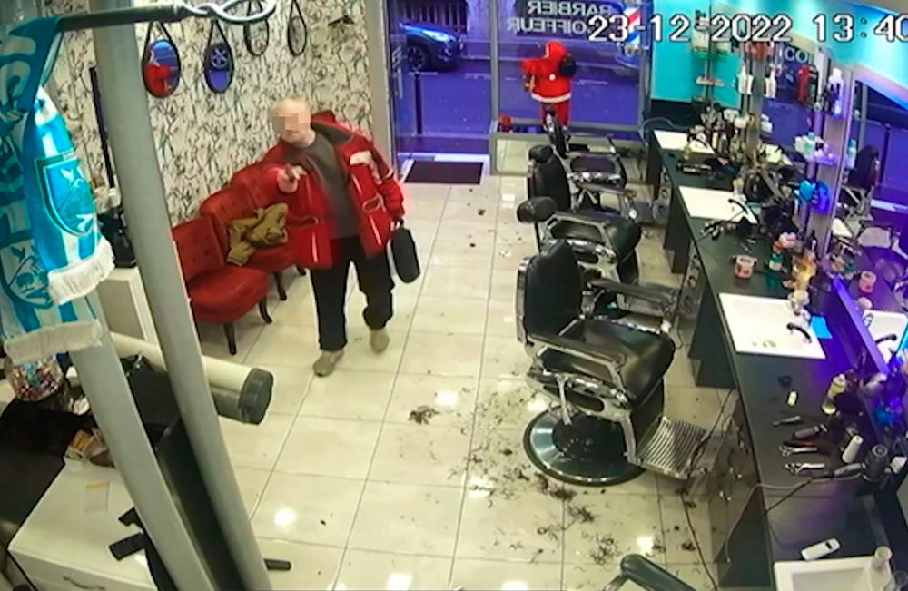 A screengrab taken from a surveillance video obtained by AFP on December 25, 2022 shows a 69-year-old French gunman entering a hairdressing salon on December 23, 2022 after he fired shots outside the Centre Ahmet Kaya Centre democratique du Kurdistan (Kurdistan democratic centre) in Paris, killing three people and wounded others. AFPPIX