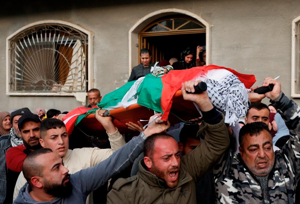 Mourners carry the body of Palestinian Jana Zakarneh during her funeral, in Jenin, in the Israeli-occupied West Bank, December 12, 2022. REUTERSPIX