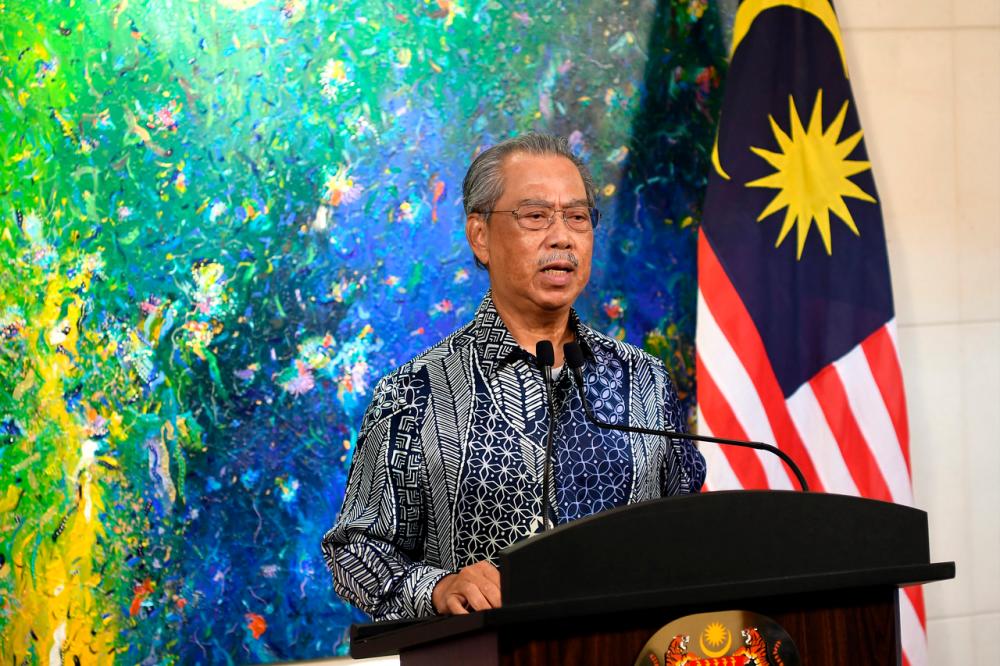 Prime Minister Tan Sri Muhyiddin Yassin delivering a speech regarding the current Covid-19 situation that was broadcasted live from his residence today.-Bernama