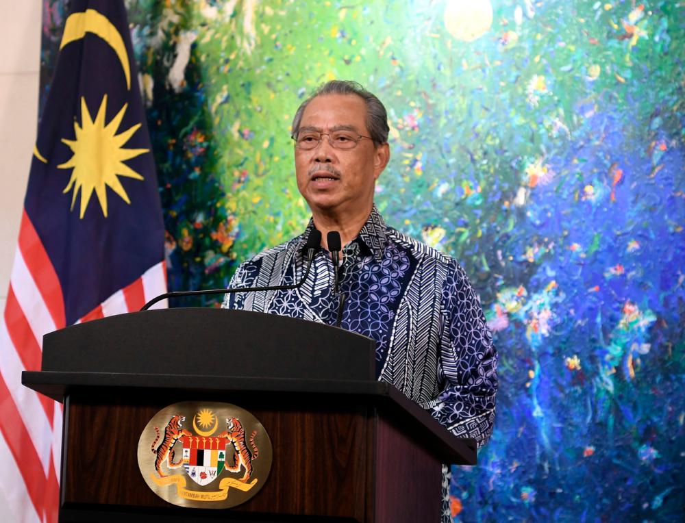 Prime Minister Tan Sri Muhyiddin Yassin delivering a speech regarding the current COVID-19 situation that was broadcasted live from his residence today. -Bernama