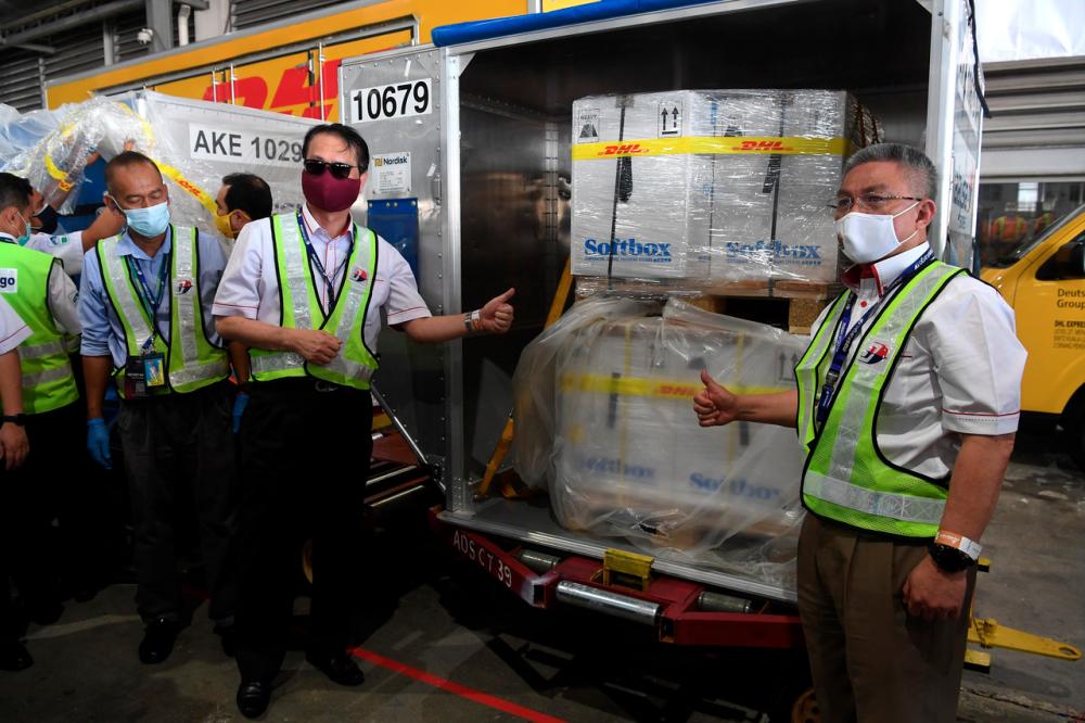 Health Minister Datuk Seri Dr Adham Baba with Health director-general Tan Sri Dr Noor Hisham Abdullah showing the box of the Pfizer-BioNTech COVID-19 vaccine at the Advanced Cargo Centre (ACC) of Kuala Lumpur International Airport (KLIA) on Feb 21.- Bernama