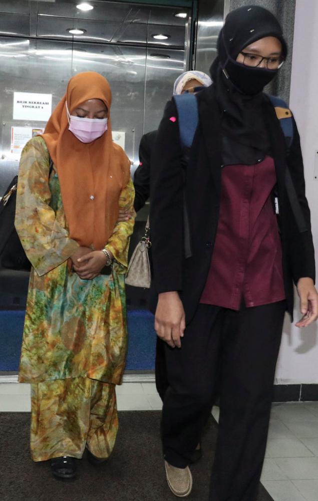 A civil servant, Norazah Abdul Aziz, (left) pleaded not guilty in the Sessions Court here today to 21 counts of submitting false claims, involving RM16,800, to the Johor Islamic Religious Department (JAINJ).- Bernama