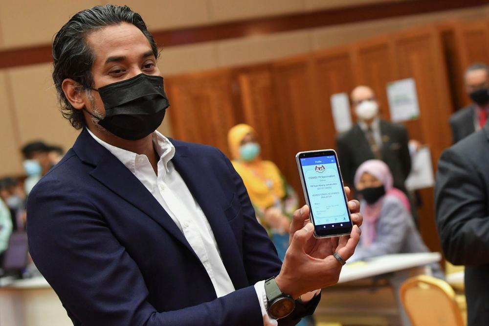 Coordinating Minister for National COVID-19 Immunisation Programme, who is also Science, Technology and Innovation Minister, Khairy Jamaluddin showing the My Sejahtera application after conducting a simulation of the National COVID-19 Immunisation Programme at Health Ministry on Feb 23.- Bernama