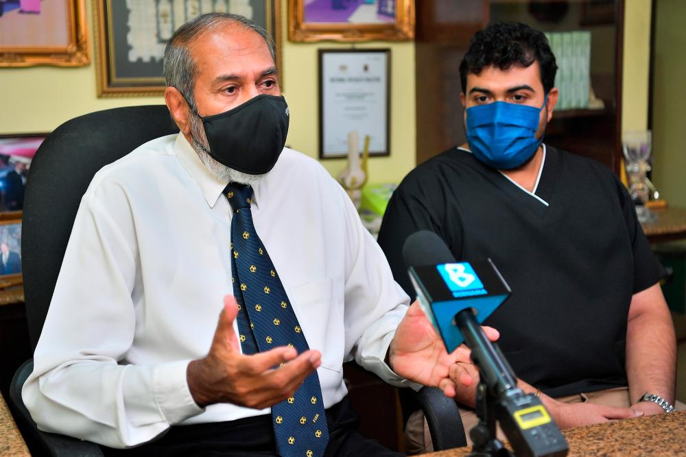 Datuk Dr Gurcharan Singh,(left) 71, and his son Dr Rachvind Singh Sra(right), 36/Bernama