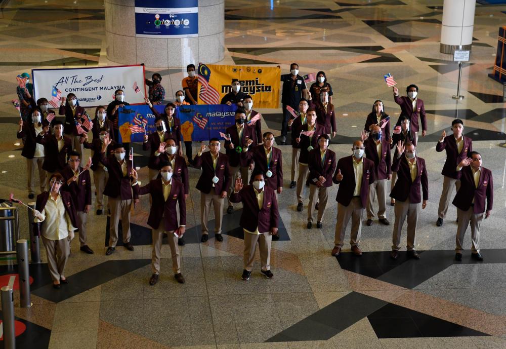 Some of the National Contingent athletes waved before leaving for Tokyo at the National Contingent’s Flag-Off to the 2020 Tokyo Olympic Games at the Kuala Lumpur International Airport (KLIA) on July 17.-Bernama