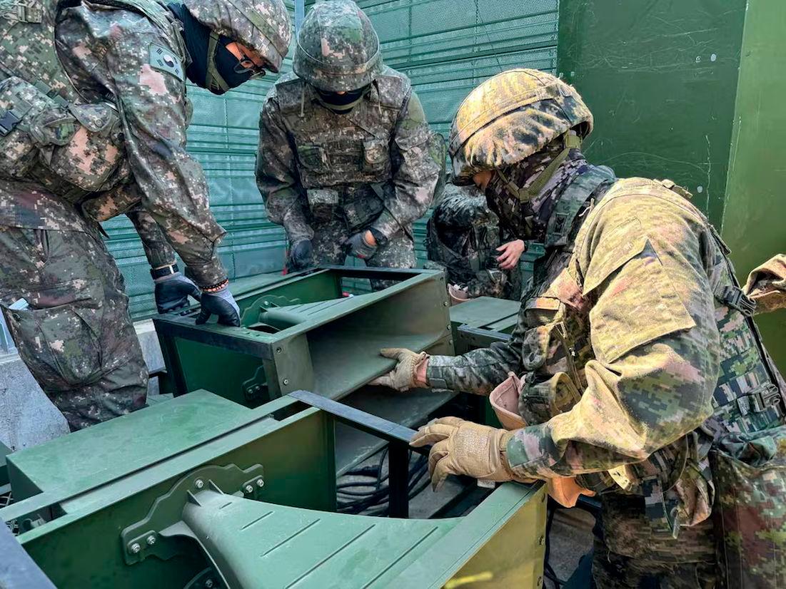 South Korean soldiers work on a loudspeaker that is set up for propaganda broadcasts during a military drill near the demilitarised zone. The Defense Ministry/Handout via REUTERS/File Photo