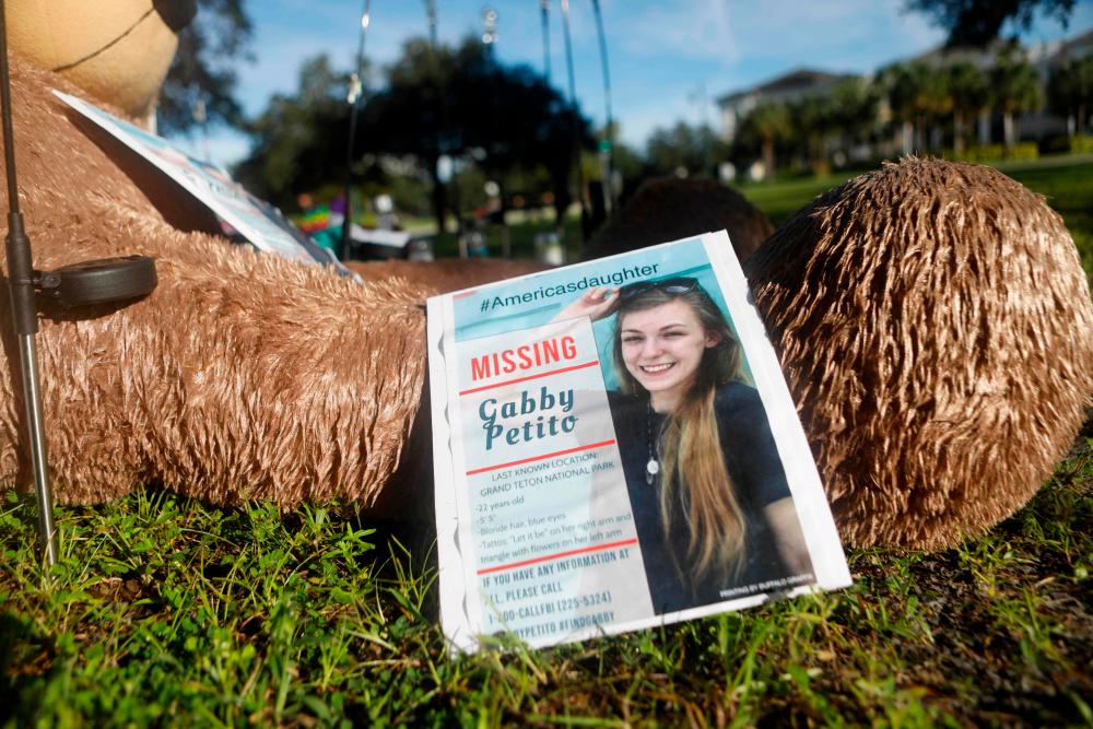 (FILES) In this file photo taken on September 20, 2021, a makeshift memorial dedicated to missing Gabby Petito is located near City Hall in North Port, Florida. The disappearance of Gabby Petito has aroused a rare and torrent media interest, re-launching the debate on what explains, or not, such a level of media exposure. The discovery of her body in Wyoming and the classification of her death as a homicide have been widely reported, going far beyond US borders. (Photo by Octavio Jones / GETTY IMAGES NORTH AMERICA / AFP)-AFPPix