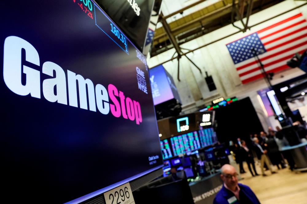 A screen displays the logo and trading information for GameStop on the floor of the New York Stock Exchange on March 29, 2022. – Reuterspic