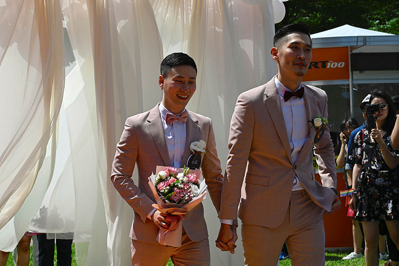 Taiwan’s first gay couple Shane Lin (R) and Marc Yuan pose for photos during a wedding ceremony in Shinyi district in Taipei on May 24, 2019. — AFP