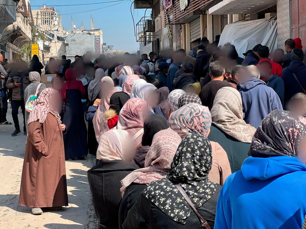 Families in Gaza wait to receive clothing aid (Shaima Al-Obaidi, Save the Children; February 27, 2025)