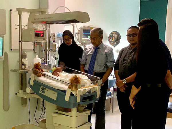 Filepix taken on June 17 shows Prime Minister Tun Dr Mahathir Mohamad visiting baby Ainul Mardhiah Ahmad Safiuddin in London during his trip there.