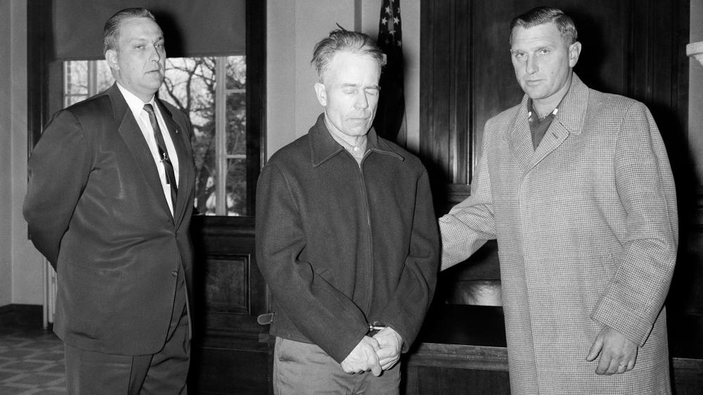 $!The butcher of Plainfield, Ed Gein (C) being led to his first court appearance by investigators.