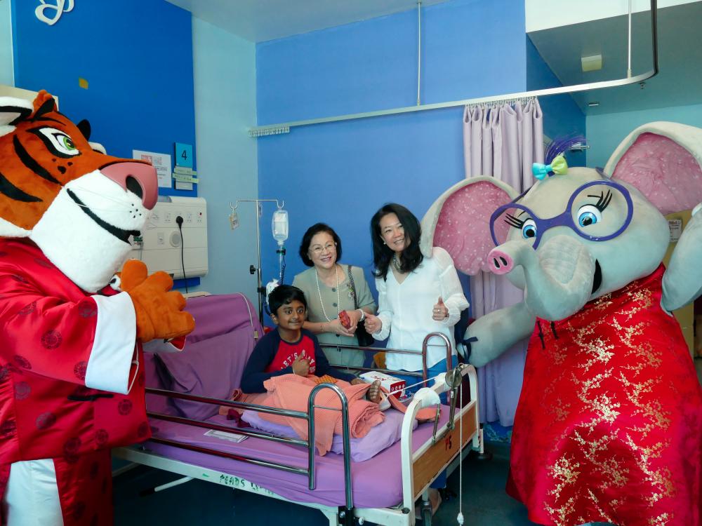 Lim (left) and Chew with the mascots and a young patient.