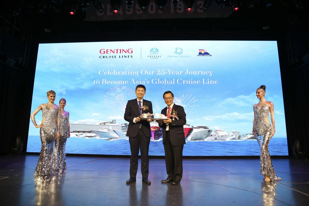 Lim (right) presenting a souvenir of the Genting Dream to Chee.
