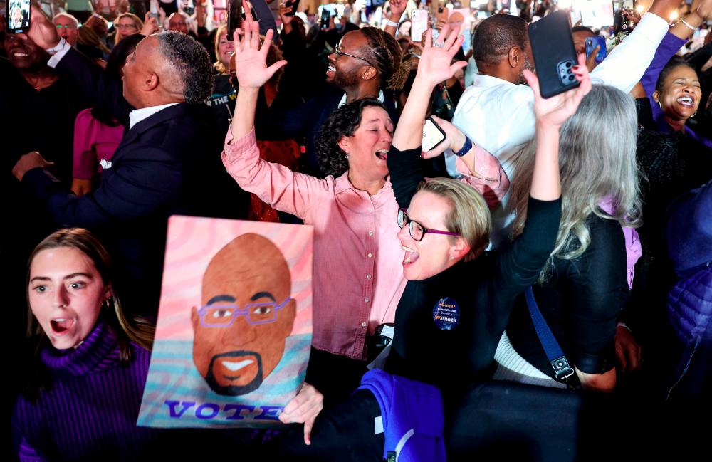 Supporters cheer as the George Senate runoff election is called for Sen. Raphael Warnock (D-GA) at the Warnock election right watch party at the Marriott Marquis/AFPPIX