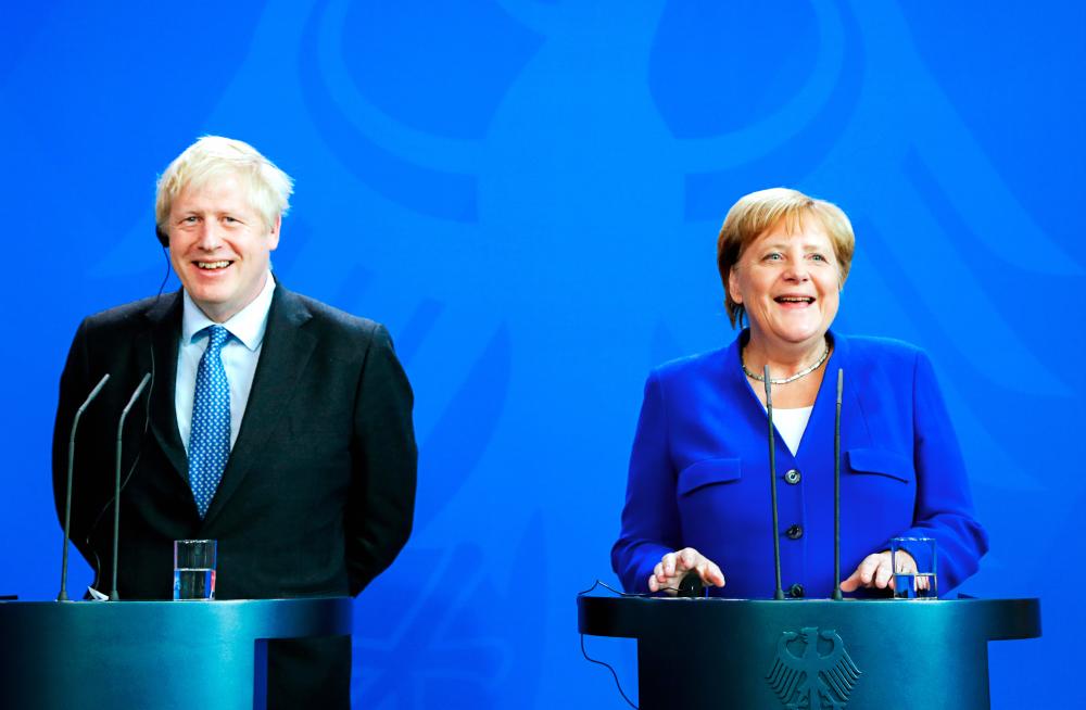German Chancellor Angela Merkel and Britain's Prime Minister Boris Johnson attend a news conference at the Chancellery in Berlin, Germany Aug 21, 2019. - Reuters
