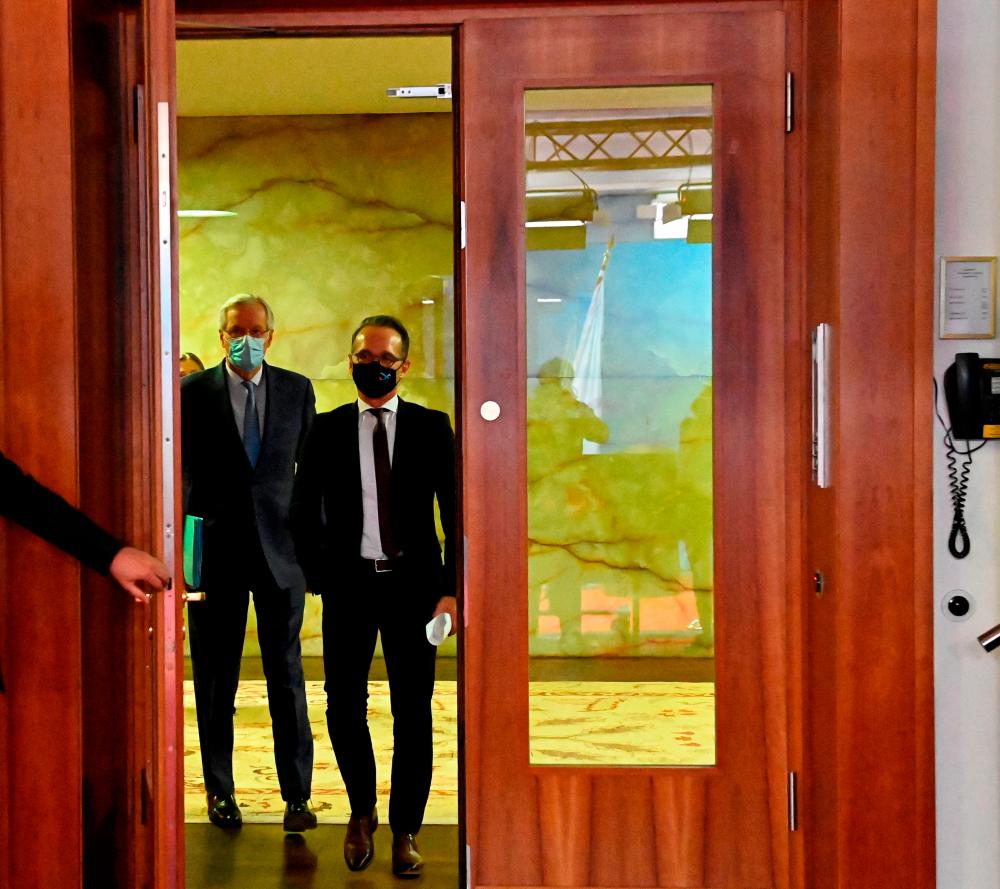 German Foreign Minister Heiko Maas and the European Union's Brexit negotiator Michel Barnier arrive to address the media following talks in Berlin, Germany on Monday. – REUTERSPIX
