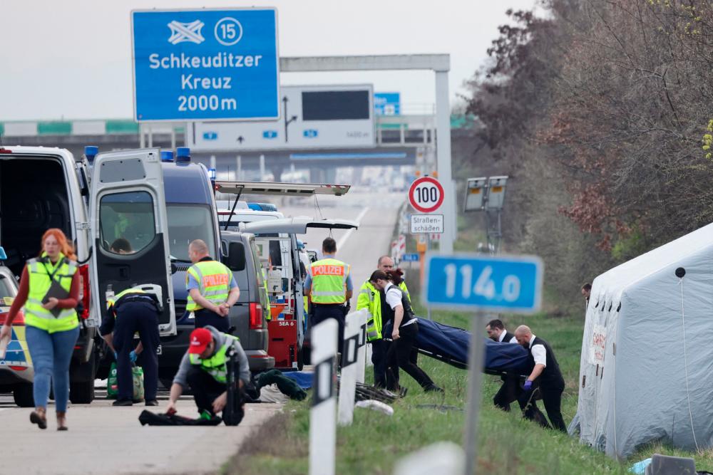 Funerary service officers carry out the body of a victim at the scene of a bus accident on the A9 highway, where at least five people were killed, on March 27, 2024 in Schkeuditz, near Leipzig, eastern Germany/AFPPix