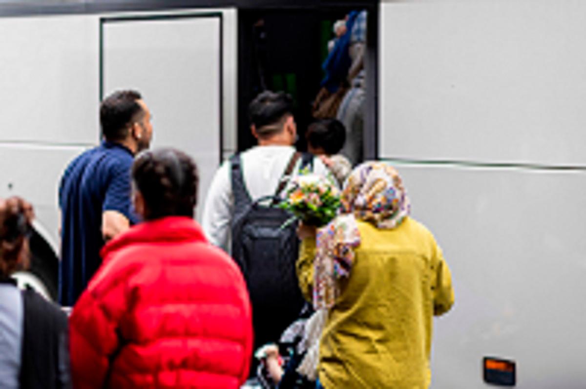 Afghan nationals board a bus after they landed at the airport in Hannover-Langenhagen, northwestern Germany, on September 1, 2025. A group of 45 Afghans who fled the Taliban arrived in Germany after months of waiting in Pakistan until German court rulings forced Berlin to offer them refuge. The 10 families have been among more then 2,000 Afghans caught in limbo in Pakistan since Germany’s new conservative-led government this year froze a programme to offer them sanctuary. - MICHAEL MATTHEY / AFP
