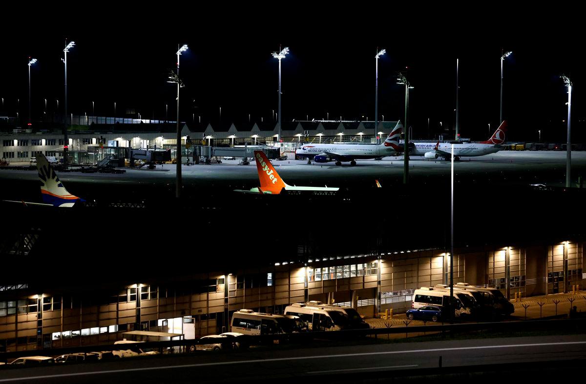 Night view shows a plane of airline EasyJet among others grounded at Munich International Airport in Munich, southern Germany, on early October 4, 2025, after reports of drone sightings again forced Munich airport to close and more than 30 flights had to be cancelled and left nearly 3,000 passengers stranded. (Photo by Michaela STACHE / AFP)