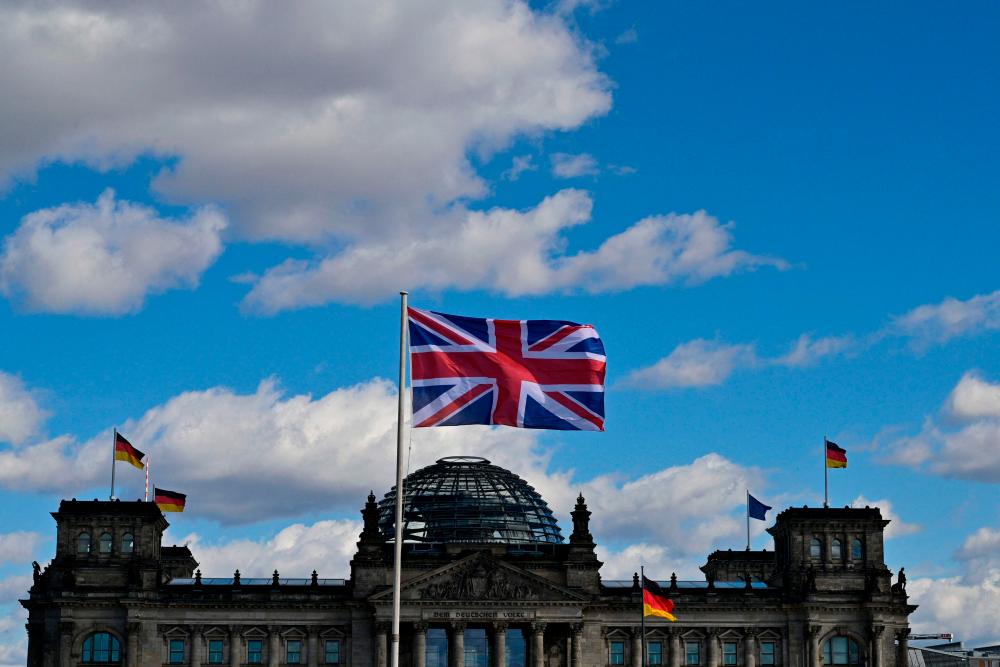 The Union Jack flies in front of the Reichstag building that houses the Bundestag (lower house of parliament) in Berlin on March 28, 2023, ahead of the visit of Britain’s King Charles III to the German capital/AFPPix