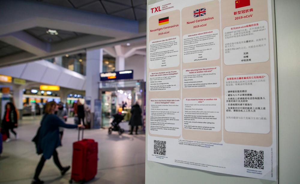 Informations in German, English and Chinese languages about the Novel Coronavirus 2019-nCoV are on display at the Tegel airport in Berlin on Jan 26. — AFP