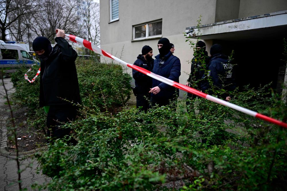 Policemen leave a building believed to be the site where a German activist of the notorious far-left Red Army Faction (RAF) wanted for more than 30 years for attempted murder and other crimes has been arrested in Berlin, on February 27, 2024/AFPPix