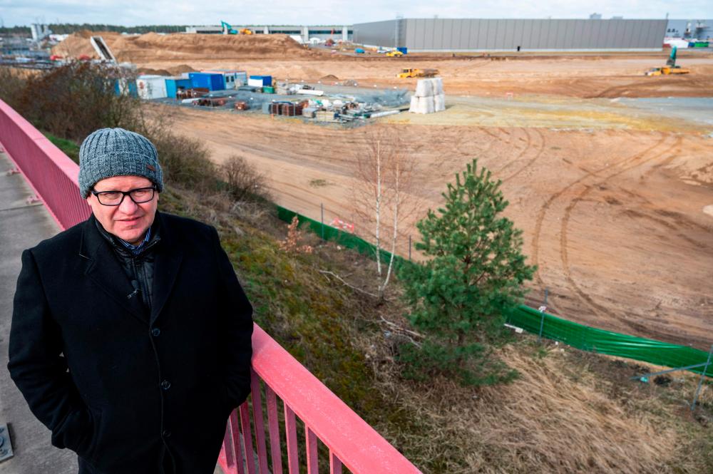 Local environmental activist Steffen Schorcht poses at the site of US electric car giant Tesla’s European “Gigafactory” in Gruenheide, near Berlin on April 8, 2021. - AFP