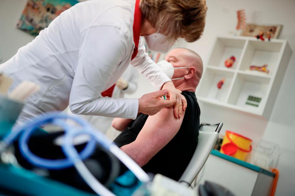 A patient receives the Astrazeneca coronavirus (Covid-19) vaccine in Senftenberg, Brandenburg, eastern Germany, on March 3, 2021, where the first vaccinations are given in doctors’ surgeries. - AFP
