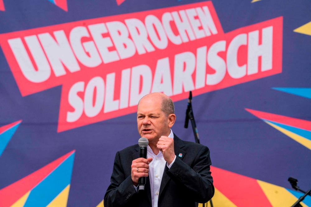 German Chancellor Olaf Scholz speaks on stage as he attends the country’s central labour day rally organised by the German Trade Union Confederation (DGB) on Mayday, May 1, 2023 in Koblenz, western Germany. AFPPIX