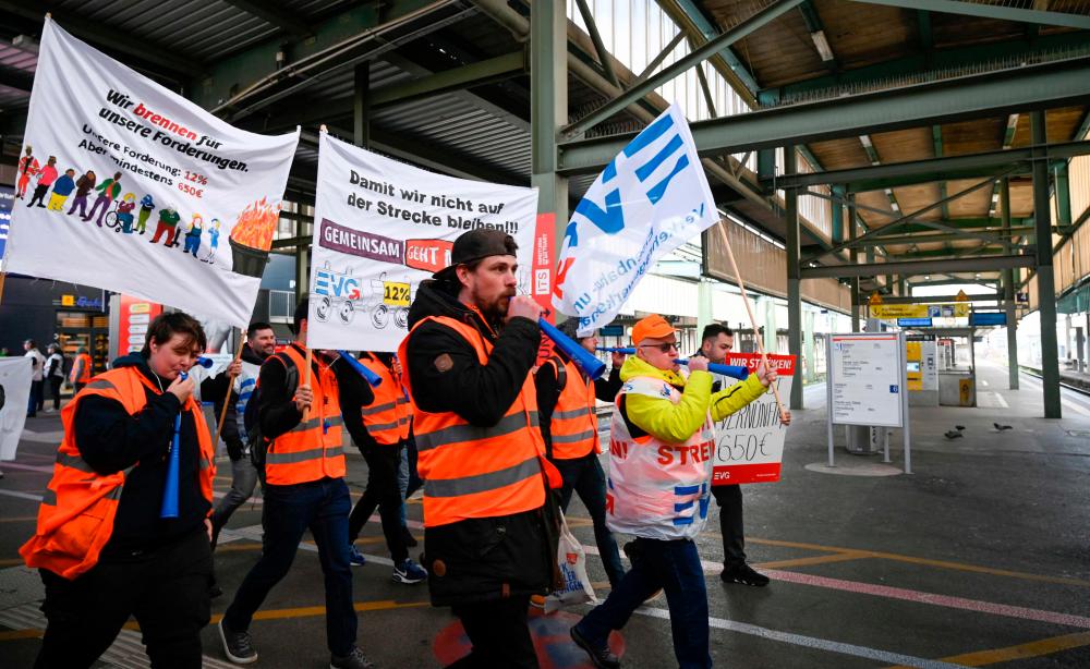 Members of the railway union EVG protest in the main railway station in Stuttgart, southern Germany, during a warning strike on March 27, 2023. AFPPIX